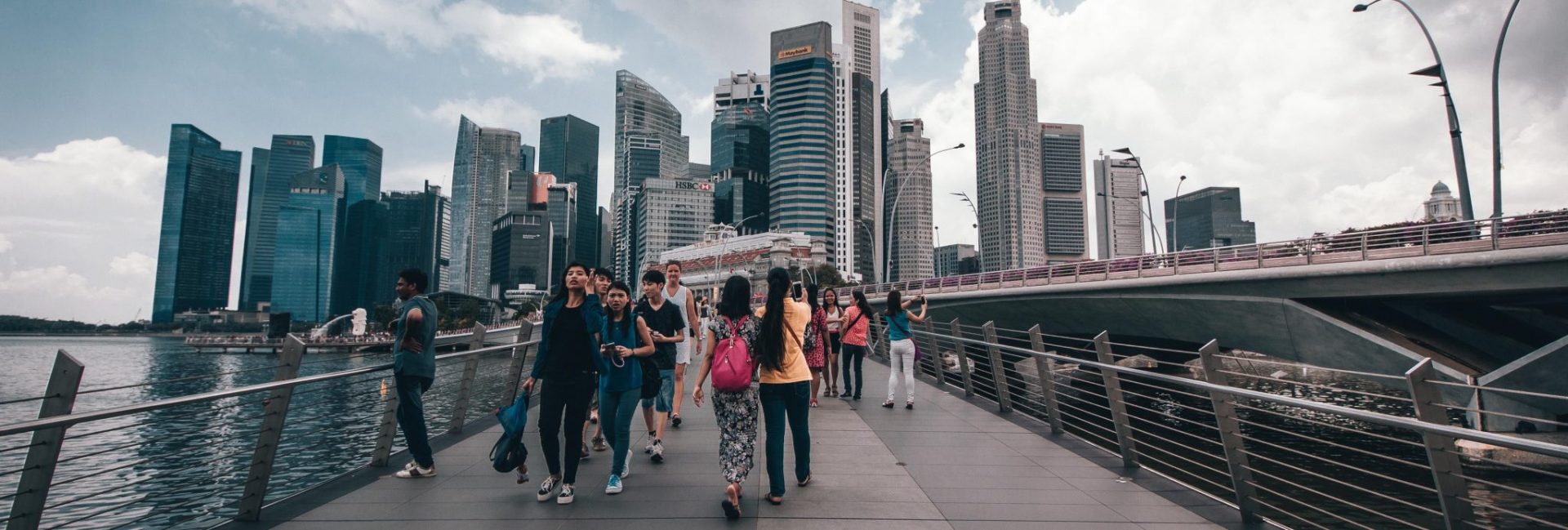 Group of people walking on a bridge.