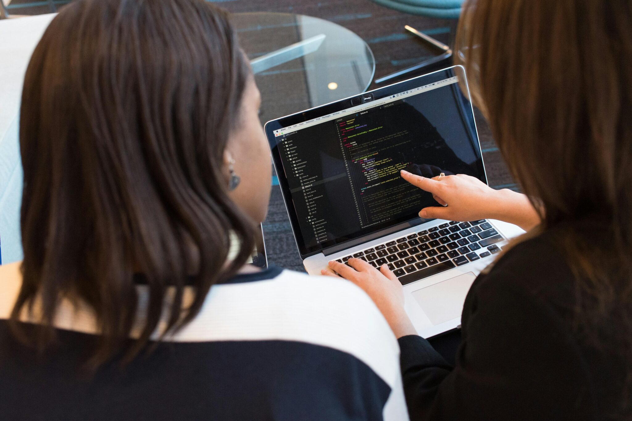 Two women looking at a laptop.