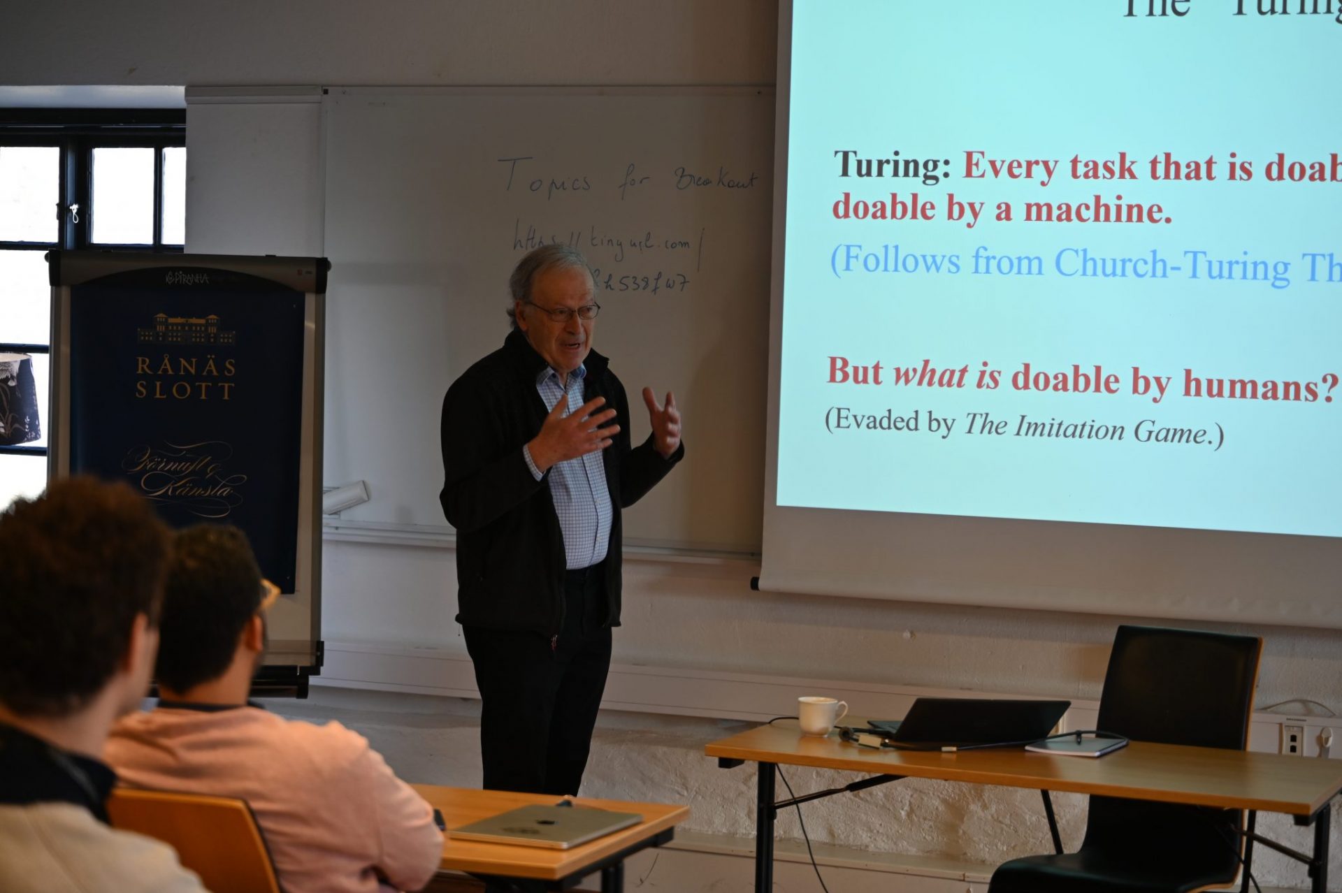 Man talking in front of a powerpoint