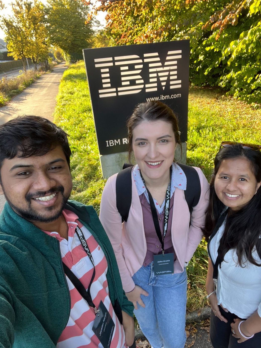 Group of people in front of an IBM sign
