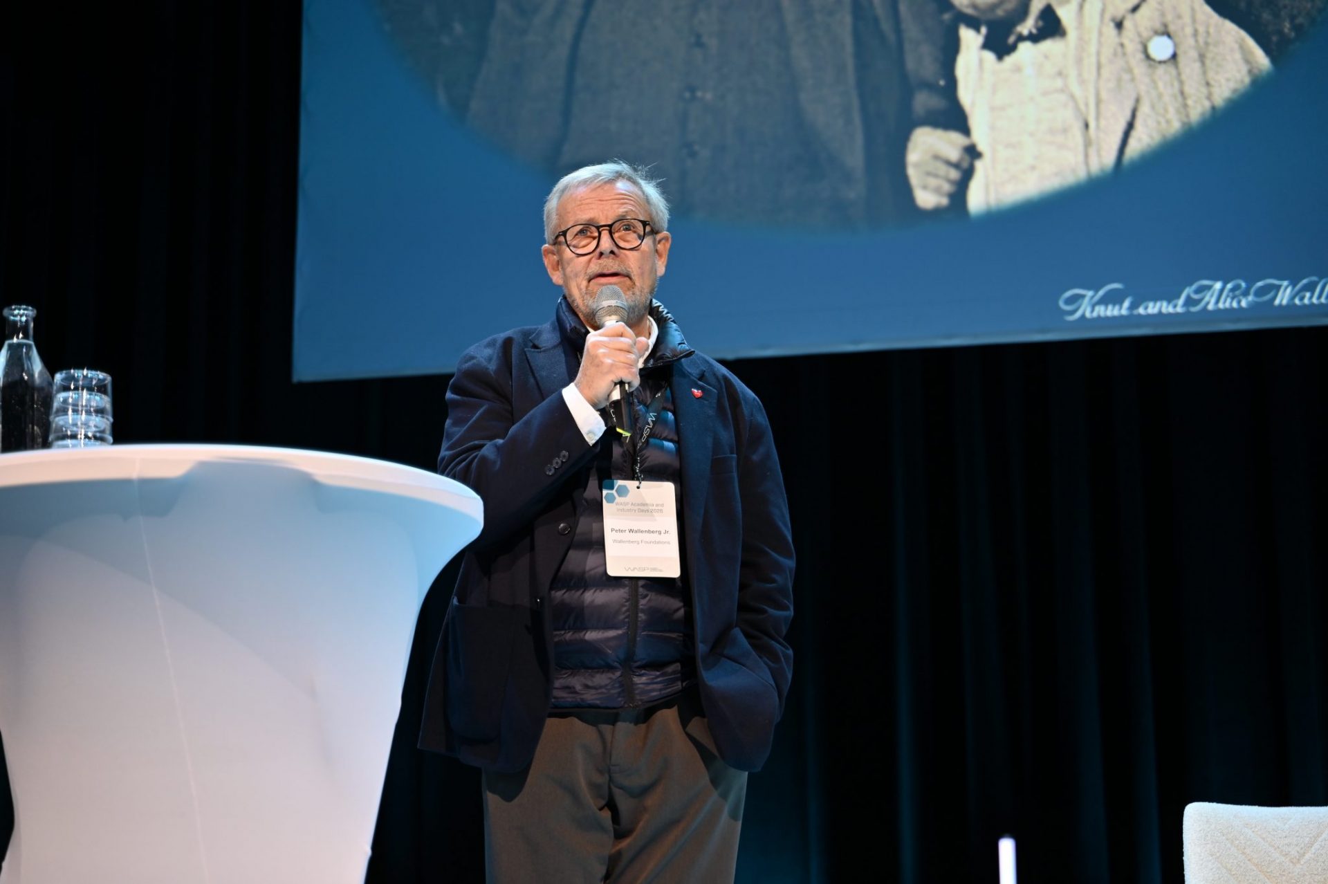 Man talking on stage with microphone