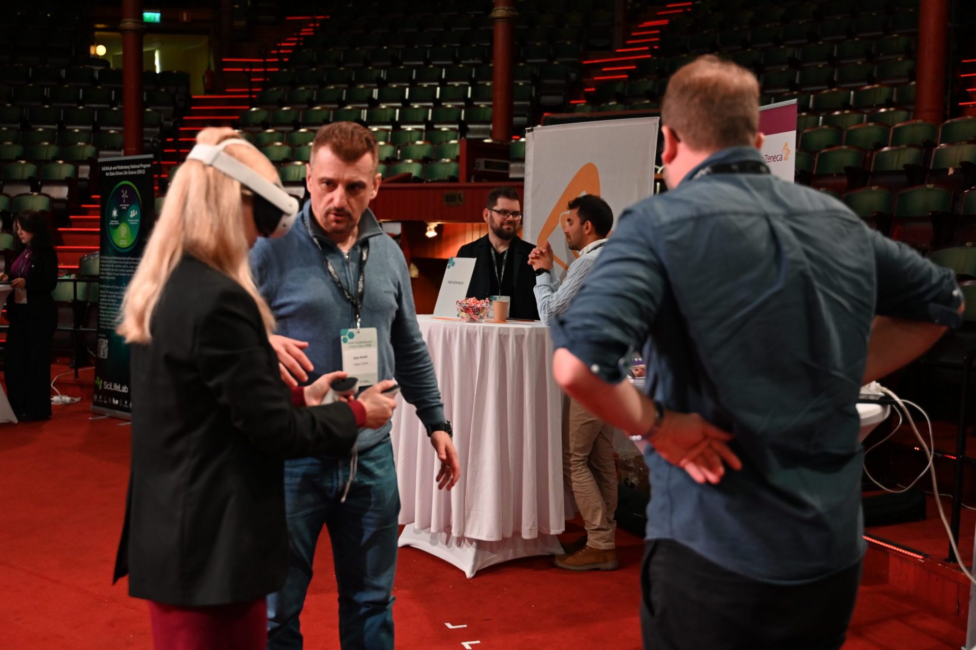 Exhibition people talking. Woman with VR.