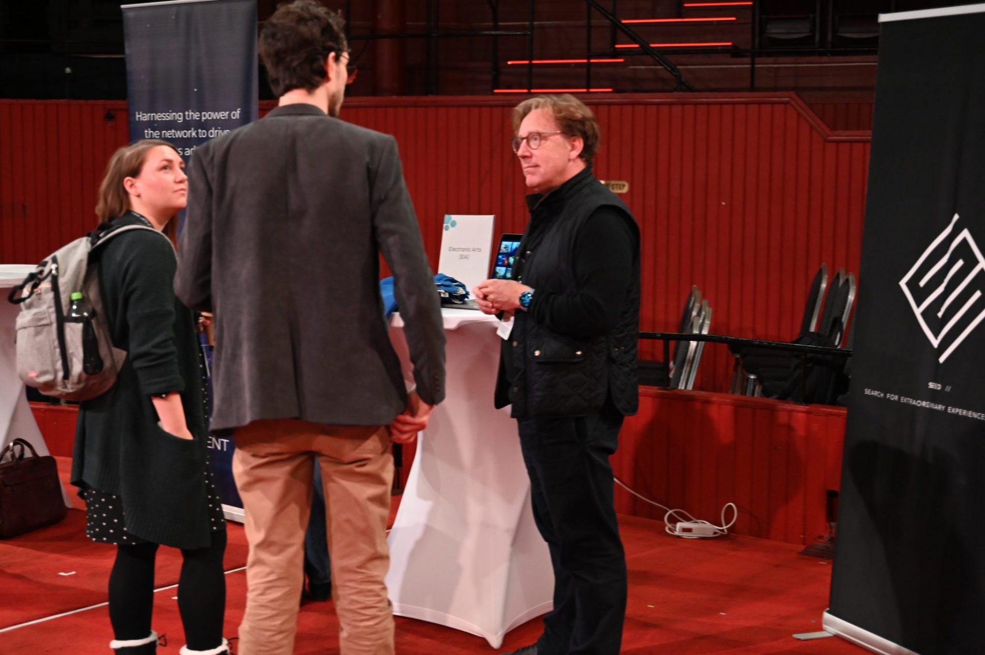 Exhibition people talking. Woman with VR.