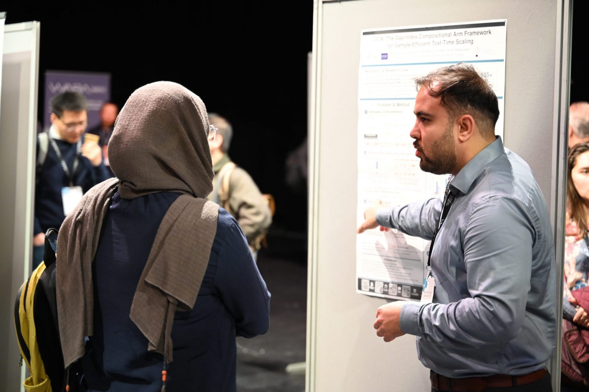 man and woman talking at poster session