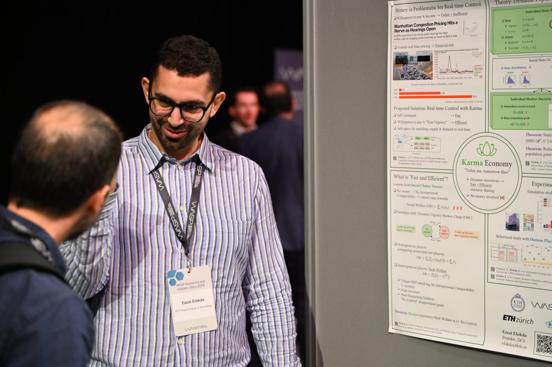 Two men talking by a poster session.