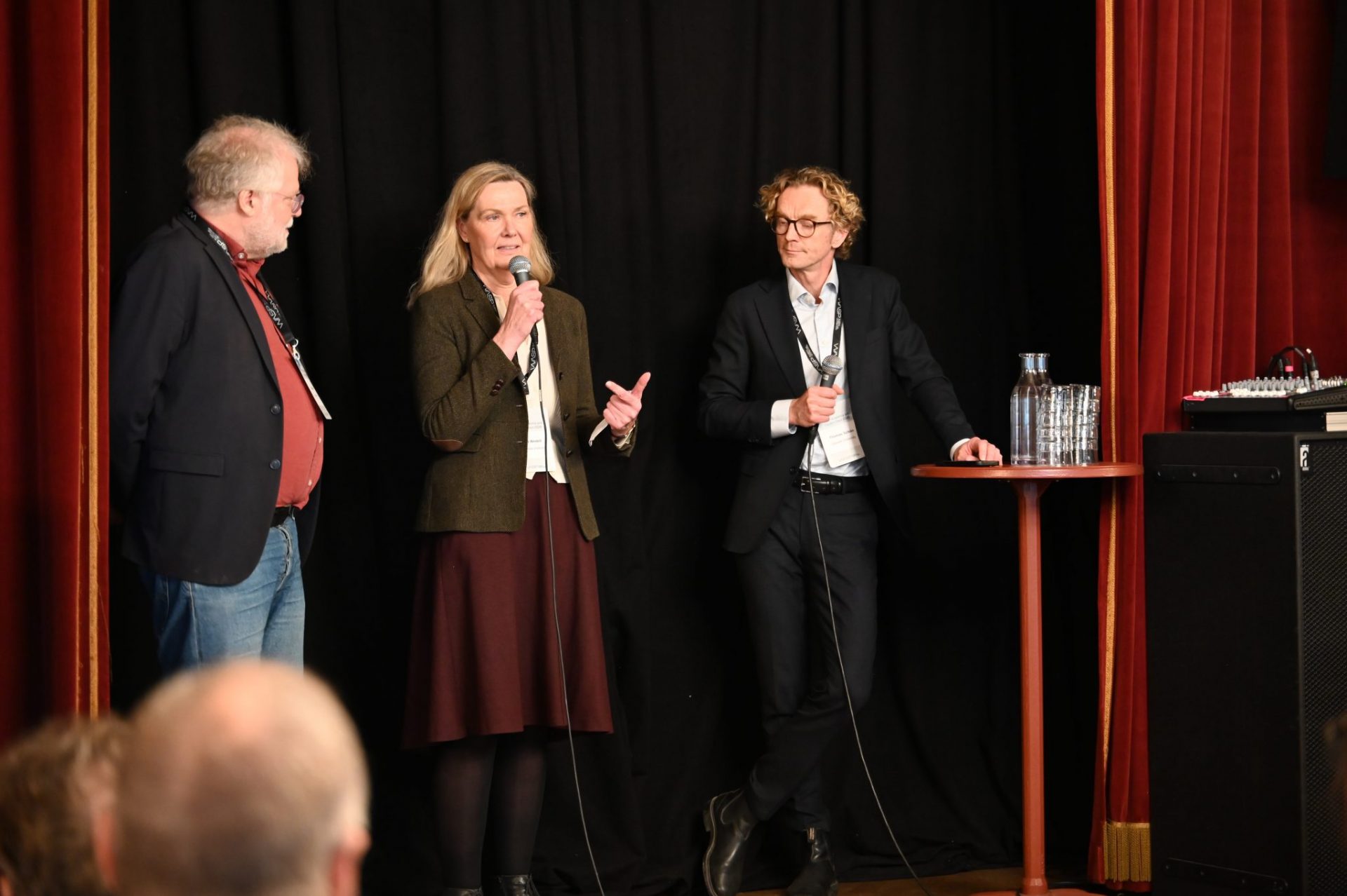 Two man and one women on stage
